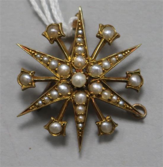 A late Victorian 15ct gold and seed pearl starburst pendant/brooch, 29mm.